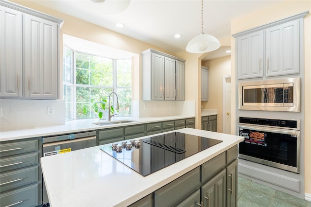 2017 Rumson Dr, Arlington, TX 76006 - kitchen with appliances with stainless steel finishes, gray cabinetry, light countertops, a sink, and recessed lighting