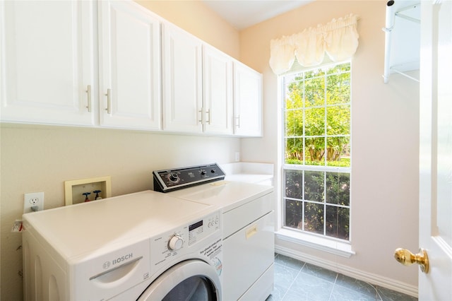 2017 Rumson Dr, Arlington, TX 76006 - laundry area with cabinet space, separate washer and dryer, baseboards, and tile patterned floors