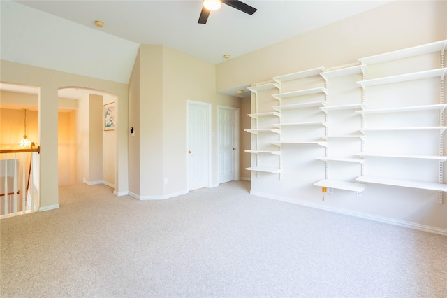 2017 Rumson Dr, Arlington, TX 76006 - spare room featuring carpet, arched walkways, ceiling fan, baseboards, and vaulted ceiling
