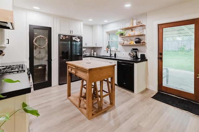 405 Valcik, Decatur, TX 76234 - kitchen featuring black appliances, a sink, under cabinet range hood, white cabinets, and dark countertops