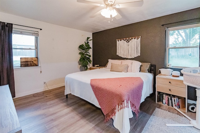 405 Valcik, Decatur, TX 76234 - bedroom with wood finished floors, multiple windows, ceiling fan, and baseboards