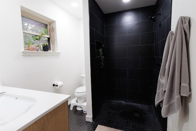 405 Valcik, Decatur, TX 76234 - bathroom featuring toilet, vanity, tiled shower, and tile patterned flooring