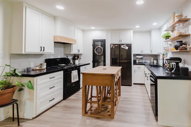 405 Valcik, Decatur, TX 76234 - kitchen with black appliances, open shelves, a sink, white cabinets, and recessed lighting