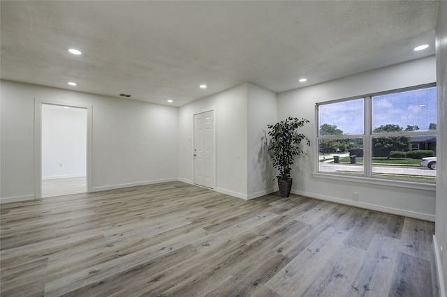 1601 Elizabeth Dr, Garland, TX 75042 - spare room with recessed lighting, wood finished floors, and baseboards