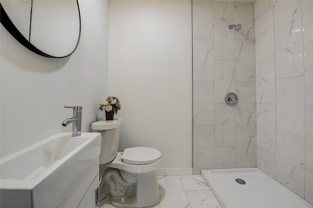 1601 Elizabeth Dr, Garland, TX 75042 - bathroom featuring marble look tiles, toilet, tiled shower, and vanity
