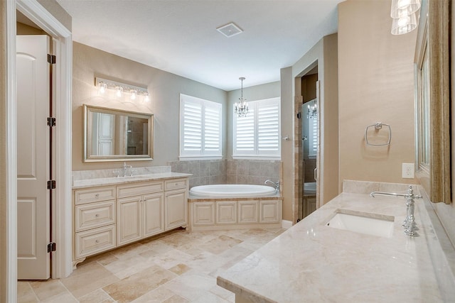 160 Solano Cir, Aledo, TX 76008 - bathroom with two vanities, a garden tub, a chandelier, and a shower stall
