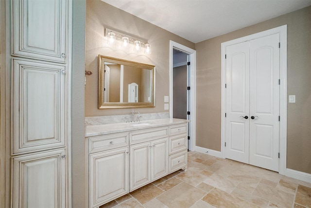 160 Solano Cir, Aledo, TX 76008 - bathroom with stone tile floors, vanity, and baseboards