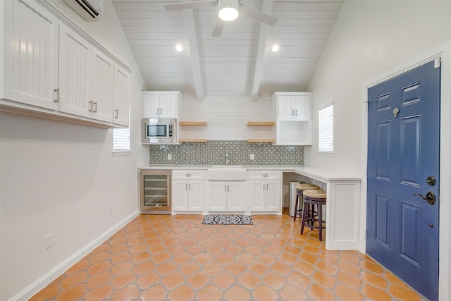160 Solano Cir, Aledo, TX 76008 - kitchen featuring stainless steel microwave, open shelves, wine cooler, a sink, and decorative backsplash