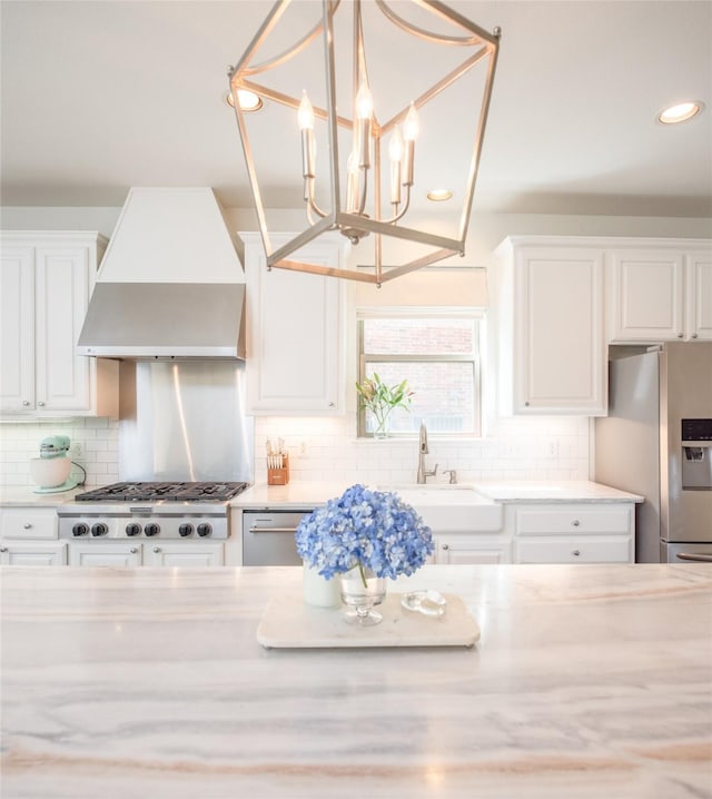 7002 Clear Springs Pkwy, Garland, TX 75044 - kitchen with wall chimney exhaust hood, a sink, stainless steel appliances, tasteful backsplash, and recessed lighting