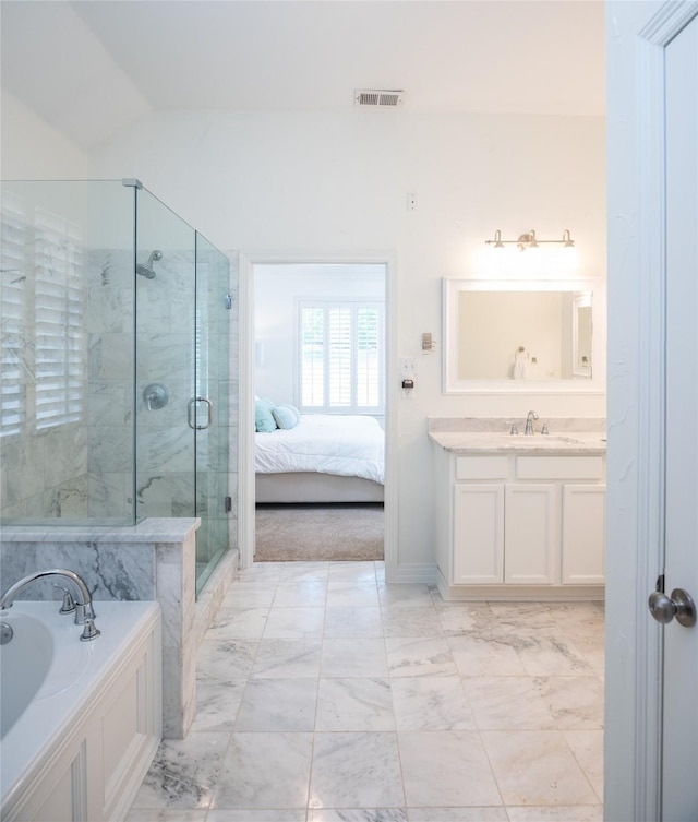 7002 Clear Springs Pkwy, Garland, TX 75044 - bathroom featuring marble finish floors, a bath, a stall shower, vanity, and ensuite bath