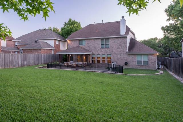 7002 Clear Springs Pkwy, Garland, TX 75044 - rear view of property featuring a chimney, a patio, brick siding, and roof with shingles