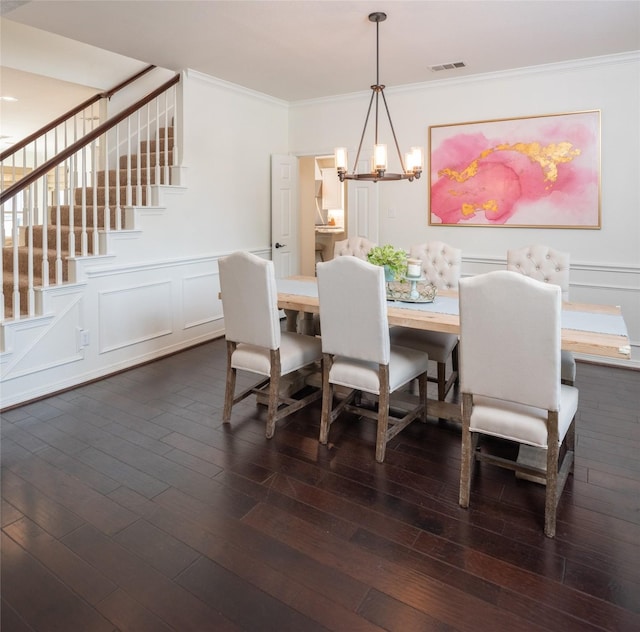 7002 Clear Springs Pkwy, Garland, TX 75044 - dining area with stairs, a chandelier, ornamental molding, dark wood-style flooring, and a wainscoted wall