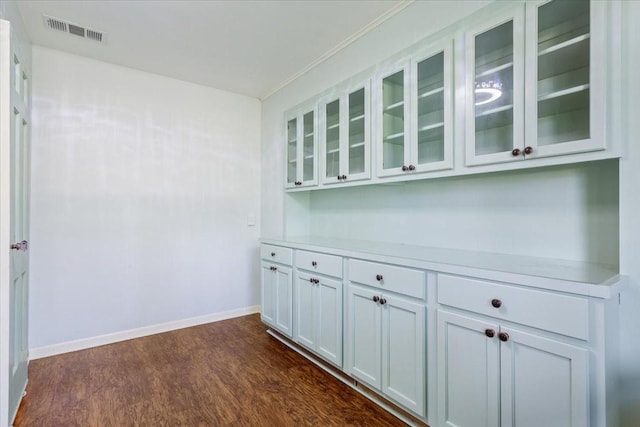 4732 Baylor Camp Rd, Crawford, TX 76638 - bar with dark wood-style floors, baseboards, and crown molding