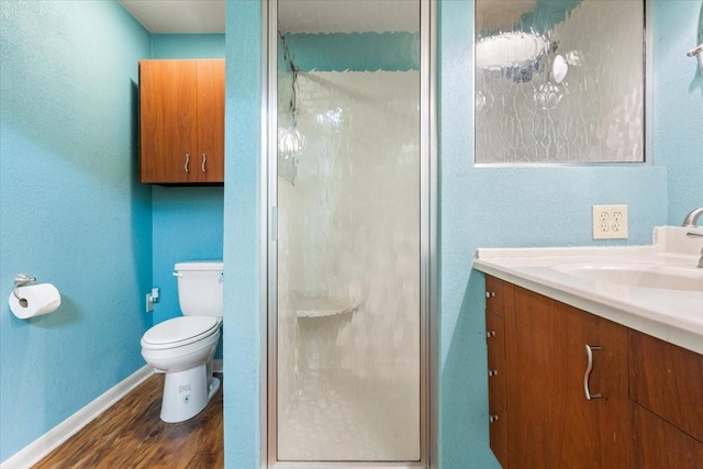 4732 Baylor Camp Rd, Crawford, TX 76638 - bathroom featuring vanity, wood finished floors, a shower stall, toilet, and baseboards