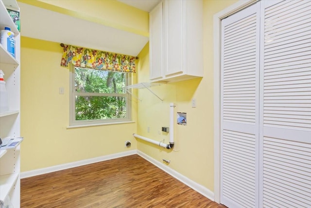 4732 Baylor Camp Rd, Crawford, TX 76638 - laundry area featuring cabinet space, wood finished floors, baseboards, and hookup for a washing machine