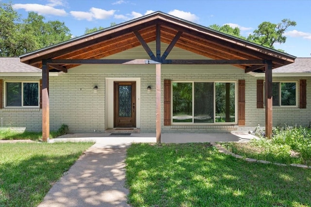 4732 Baylor Camp Rd, Crawford, TX 76638 - property entrance with brick siding, a yard, and a shingled roof