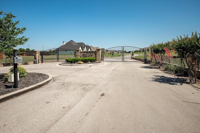 1025 Aledo Ridge Ct, Fort Worth, TX 76108 - view of concrete street with a gate, a gated entry, and curbs
