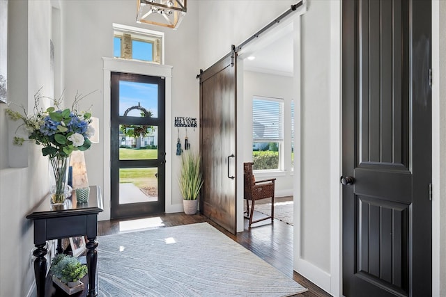 1025 Aledo Ridge Ct, Fort Worth, TX 76108 - entrance foyer with dark wood-style flooring, a barn door, and a towering ceiling