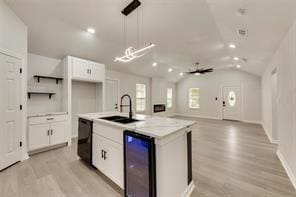 1320 E 3rd Ave, Corsicana, TX 75110 - kitchen with a sink, wine cooler, black dishwasher, lofted ceiling, and white cabinetry