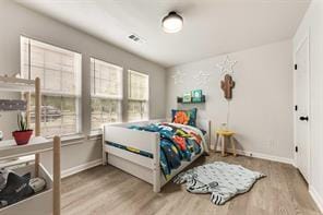 1320 E 3rd Ave, Corsicana, TX 75110 - bedroom with wood finished floors and baseboards
