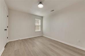 1320 E 3rd Ave, Corsicana, TX 75110 - spare room with wood finished floors and baseboards