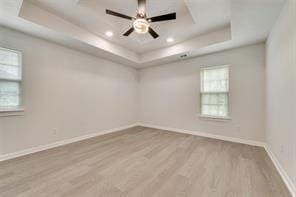 1320 E 3rd Ave, Corsicana, TX 75110 - spare room with a tray ceiling, wood finished floors, baseboards, a ceiling fan, and recessed lighting