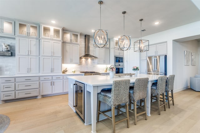 3525 Dancer Rd, Celina, TX 75009 - kitchen with wall chimney exhaust hood, beverage cooler, appliances with stainless steel finishes, a chandelier, and decorative backsplash