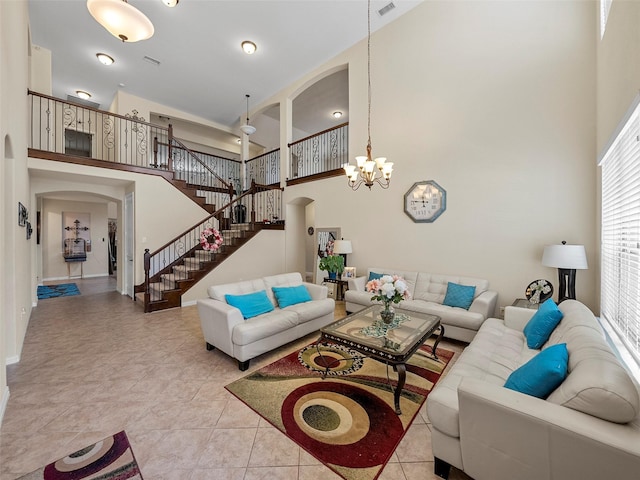 5207 Seth Ave, Sachse, TX 75048 - living area featuring arched walkways, a towering ceiling, a chandelier, stairway, and baseboards
