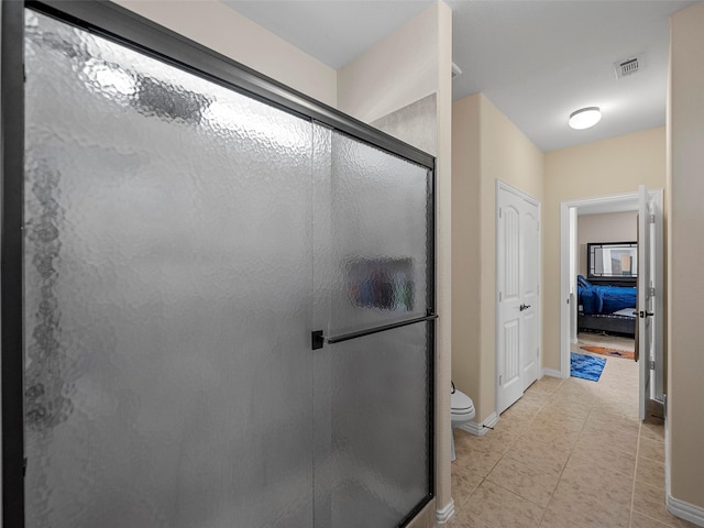 5207 Seth Ave, Sachse, TX 75048 - ensuite bathroom with a stall shower, toilet, tile patterned floors, and baseboards