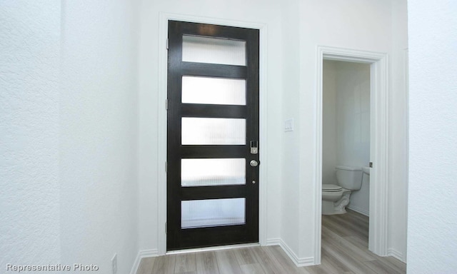 3806 Aqua Ln, Sherman, TX 75090 - foyer entrance with light wood finished floors, baseboards, and a textured wall