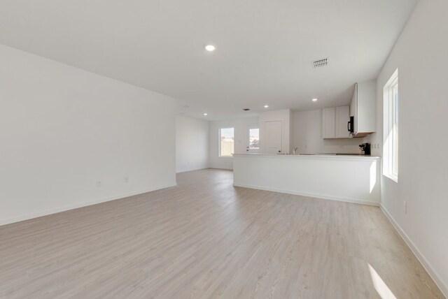 652 Criner St, Grandview, TX 76050 - unfurnished living room with light wood-style floors and recessed lighting