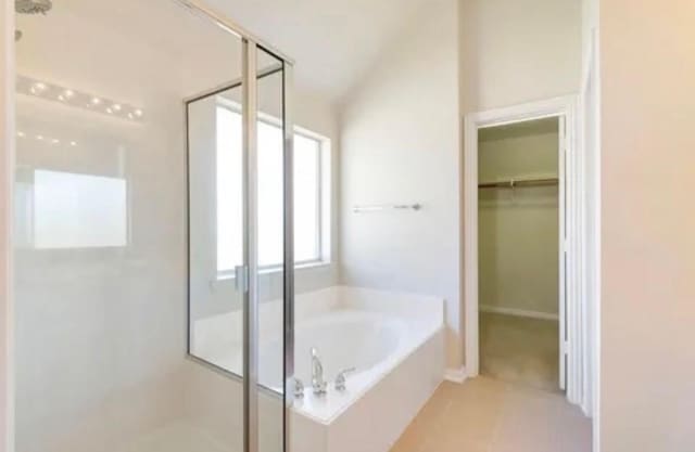 7807 Enchanted Isle Dr, Arlington, TX 76016 - full bath with a shower stall, a bath, a spacious closet, and tile patterned flooring