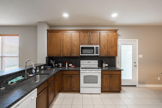 7807 Enchanted Isle Dr, Arlington, TX 76016 - kitchen with white appliances, a sink, decorative backsplash, brown cabinetry, and recessed lighting