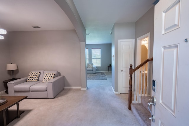 7807 Enchanted Isle Dr, Arlington, TX 76016 - living room featuring light colored carpet, arched walkways, stairway, and baseboards