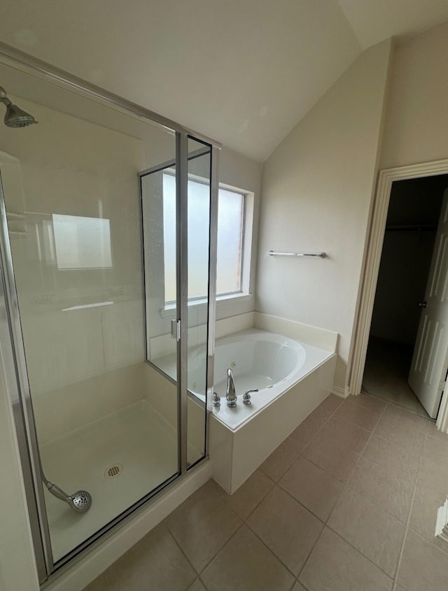 7807 Enchanted Isle Dr, Arlington, TX 76016 - bathroom with a shower stall, tile patterned floors, vaulted ceiling, a garden tub, and a spacious closet