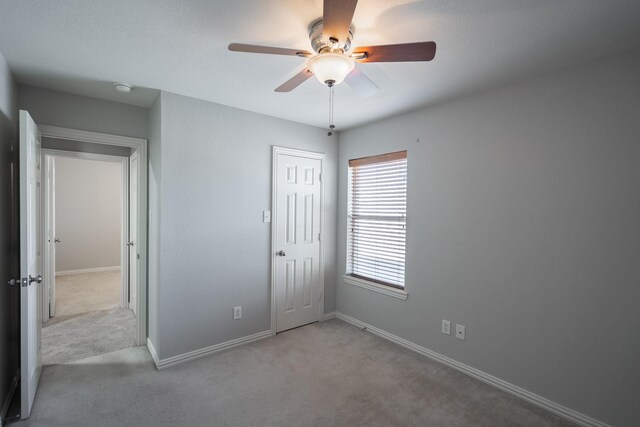 7807 Enchanted Isle Dr, Arlington, TX 76016 - unfurnished bedroom featuring carpet, baseboards, a closet, and ceiling fan