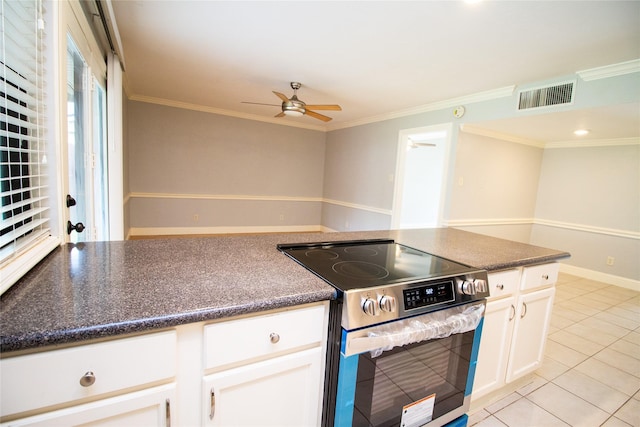 9001 Westfield Dr, Rowlett, TX 75088 - kitchen featuring stainless steel range with electric stovetop, a ceiling fan, white cabinets, light tile patterned floors, and crown molding