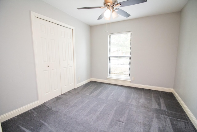 9001 Westfield Dr, Rowlett, TX 75088 - unfurnished bedroom with dark carpet, a closet, baseboards, and a ceiling fan