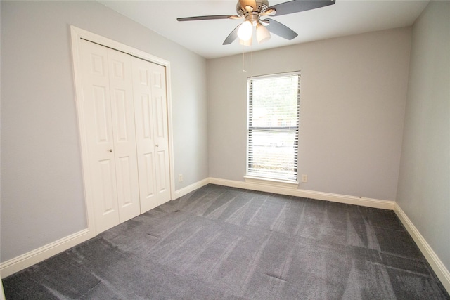 9001 Westfield Dr, Rowlett, TX 75088 - unfurnished bedroom with dark carpet, a closet, baseboards, and ceiling fan