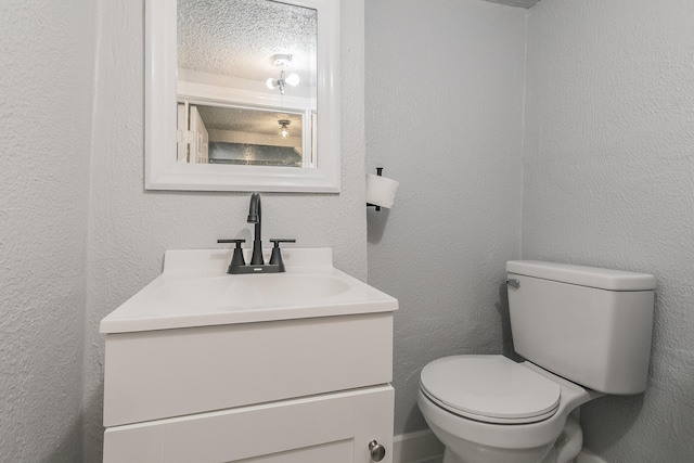 408 E Baylor St, Weatherford, TX 76086 - half bathroom with vanity, toilet, and a textured wall