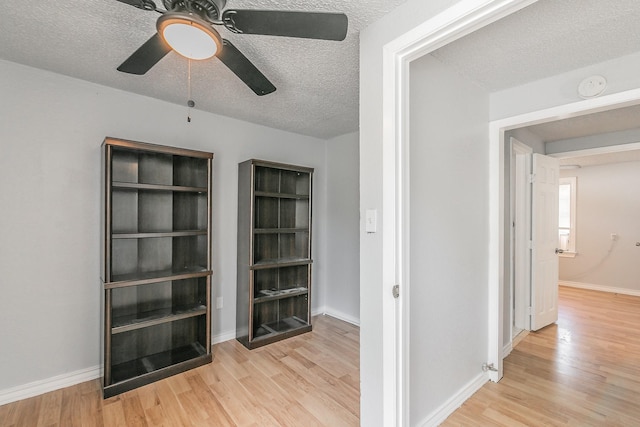 408 E Baylor St, Weatherford, TX 76086 - corridor featuring wood finished floors, a textured ceiling, and baseboards