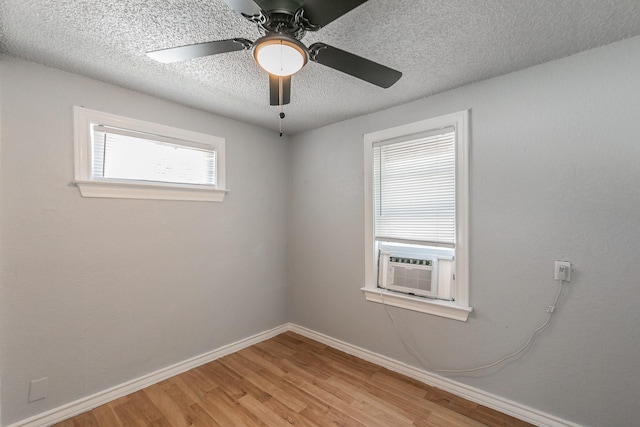 408 E Baylor St, Weatherford, TX 76086 - empty room featuring wood finished floors, ceiling fan, baseboards, cooling unit, and a textured ceiling