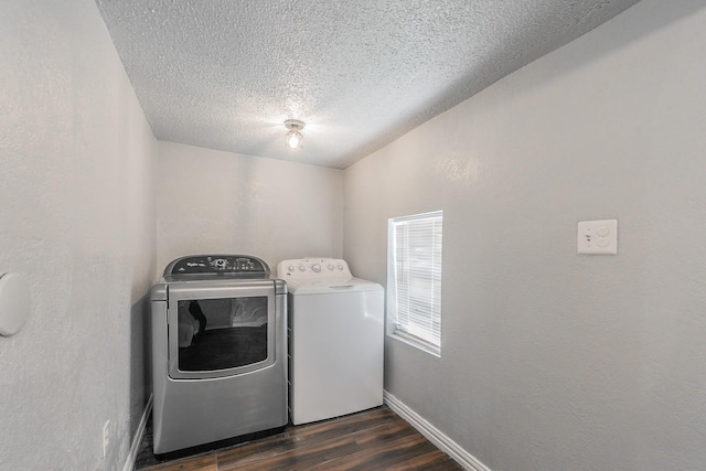 408 E Baylor St, Weatherford, TX 76086 - washroom featuring washing machine and clothes dryer, dark wood finished floors, a textured ceiling, and baseboards