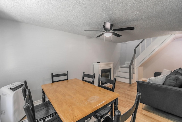 408 E Baylor St, Weatherford, TX 76086 - dining space featuring light wood-style flooring, ceiling fan, stairway, and a textured ceiling