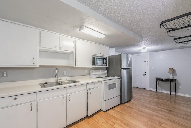 408 E Baylor St, Weatherford, TX 76086 - kitchen with appliances with stainless steel finishes, a sink, a textured ceiling, open shelves, and white cabinetry