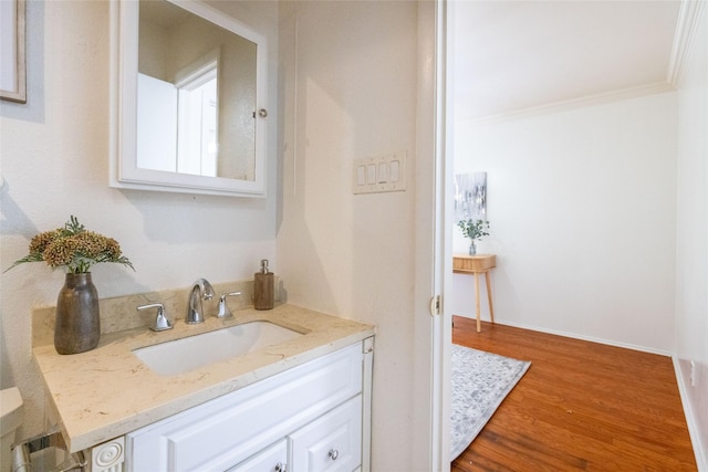 817 Edgehill Dr, Hurst, TX 76053 - bathroom featuring vanity, wood finished floors, and ornamental molding