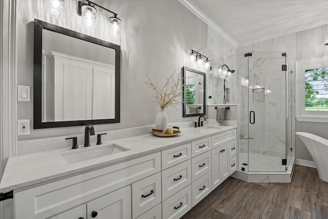 820 Windlake Cir, Heath, TX 75032 - full bathroom featuring a marble finish shower, double vanity, a freestanding tub, wood finished floors, and ornamental molding