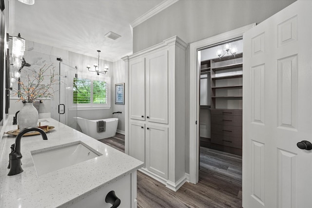 820 Windlake Cir, Heath, TX 75032 - full bath featuring a chandelier, crown molding, wood finished floors, a freestanding tub, and a stall shower