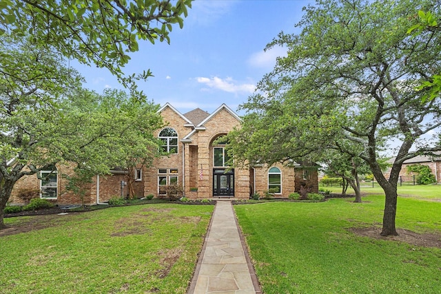 820 Windlake Cir, Heath, TX 75032 - traditional-style house with a front yard and brick siding