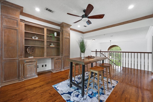 820 Windlake Cir, Heath, TX 75032 - office area with built in study area, a ceiling fan, dark wood-style floors, a textured ceiling, and crown molding